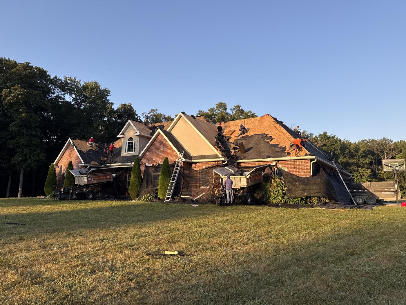 MPR Roofing crew tearing off old shingles on a brick home in Southern Illinois